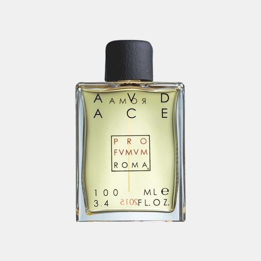 A square glass bottle of Profumum Roma Audace, featuring a minimalist design with a black cap and yellow-green fragrance visible inside. The label displays the brand name and product details.