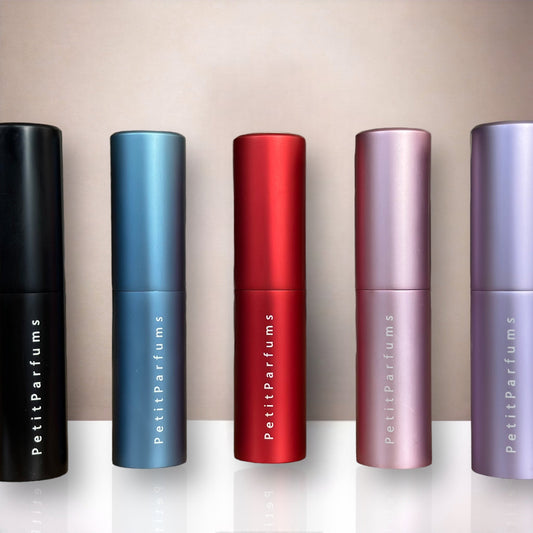 Travel Spray 5 ML - PetitParfums features a collection of sleek, portable fragrance spray bottles in various metallic colors, including black, blue, red, and pink. Ideal for on-the-go refreshment, each bottle is elegantly designed for easy carrying.