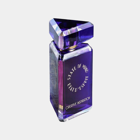 A striking purple bottle of 'State of Mind Creative Inspiration Sample' fragrance, featuring a geometric design and elegant label. The unique triangular cap adds a touch of creativity to the overall aesthetic.