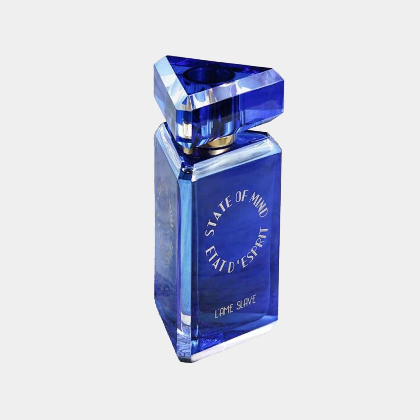 A blue, triangular bottle of State of Mind L'Ame Slave Sample fragrance, featuring a sleek design with gold accents and elegant lettering. The perfume exudes a sophisticated and luxurious aesthetic.
