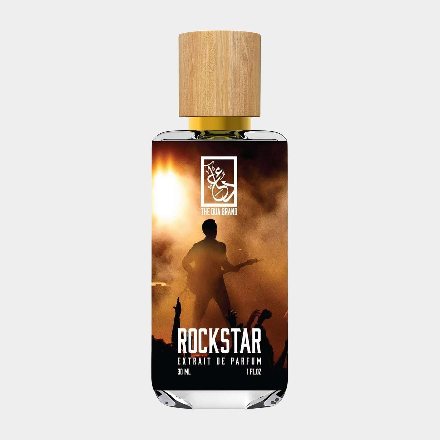 A bottle of Dua Rockstar Sample fragrance, featuring a sleek design with a wooden cap and a label showcasing a silhouette of a performer against a vibrant concert backdrop. The bottle contains 30 mL of perfume.