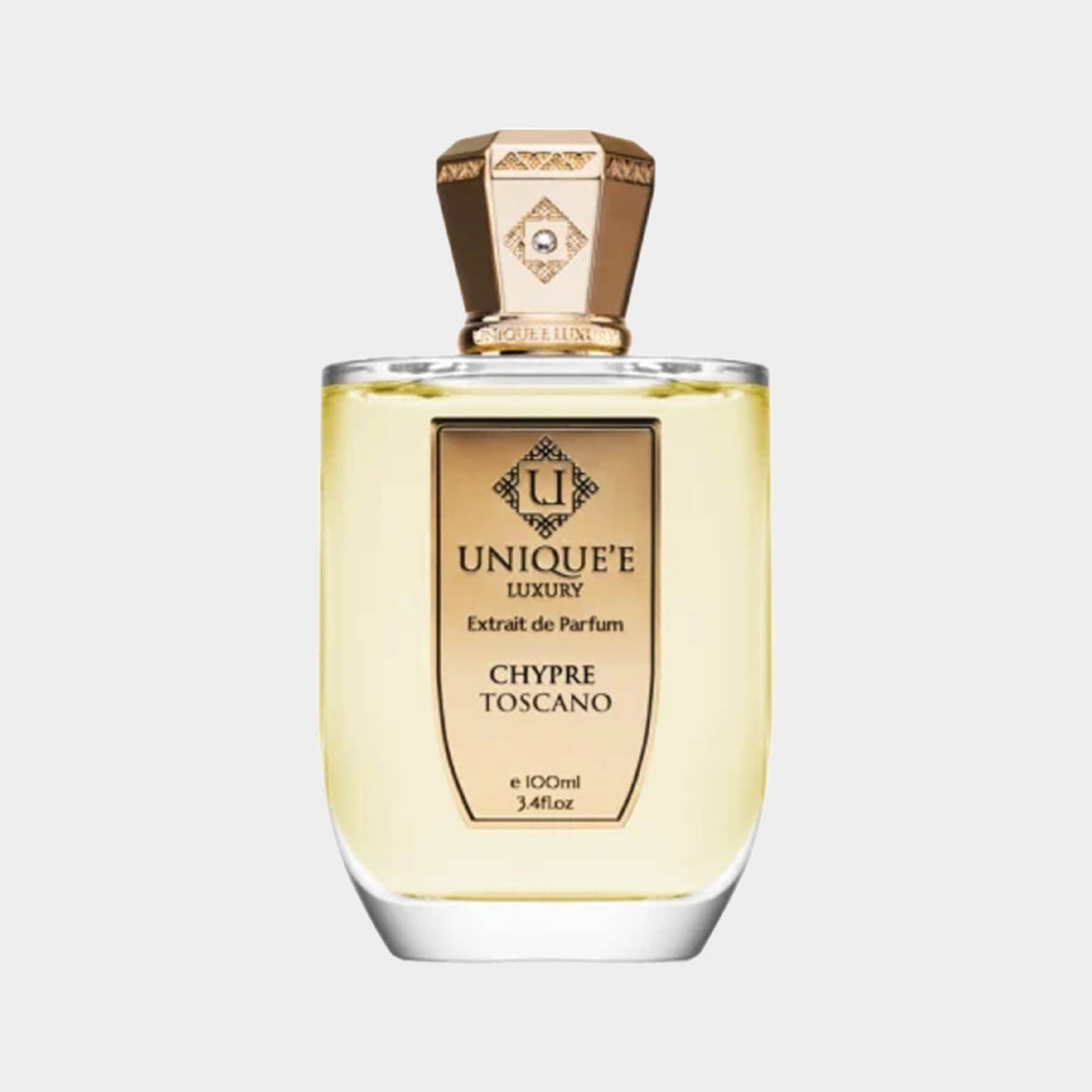 A stylish bottle of Unique'e Luxury Chypre Toscano Sample, showcasing a luxurious golden liquid within a clear glass container, topped with an elegant cap. The label features ornate detailing and the brand name prominently displayed.