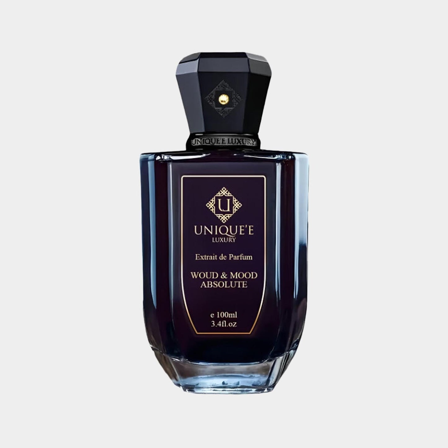 A luxurious 100ml bottle of Unique'e Luxury Woud and Mood Absolute Extrait de Parfum, featuring an elegant dark glass design and a striking faceted cap.