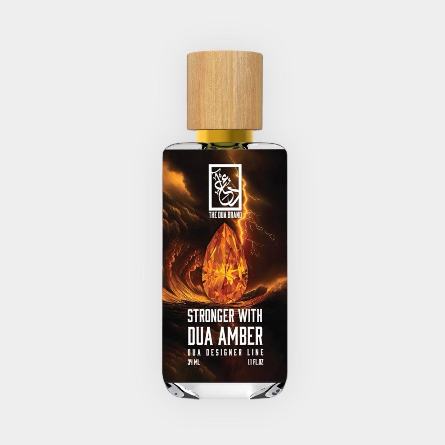 A bottle of Stronger With Dua Amber fragrance from The Dua Brand, featuring an elegant design with a wooden cap and a golden amber drop graphic, set against a dark background.