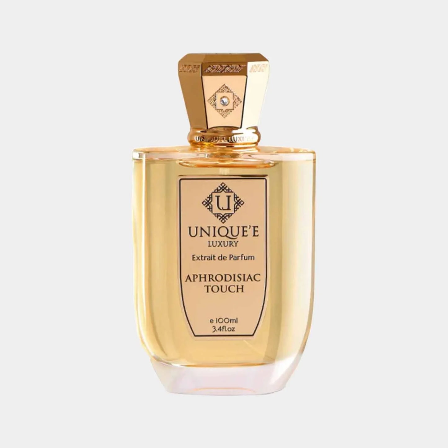 A full 100ml bottle of Unique'e Luxury Aphrodisiac Touch, featuring an elegant golden cap and a chic label. The perfume's warm amber liquid is designed to evoke sensuality and allure.