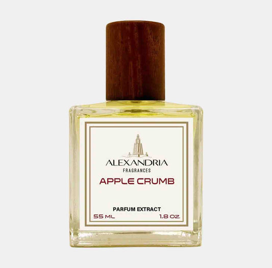 A bottle of Alexandria Fragrances Apple Crumb Sample, featuring a clear glass design with a wooden cap, labeled with the fragrance name and volume details.