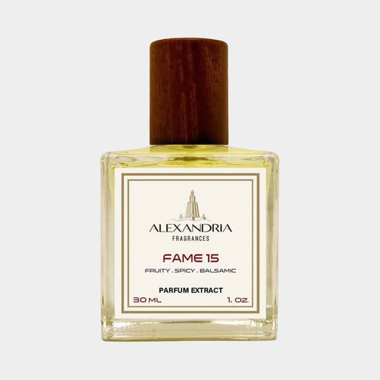 A 30 mL bottle of Alexandria Fragrances Fame 15, featuring a clear glass container with a wooden cap. The perfume is described as fruity, spicy, and balsamic.