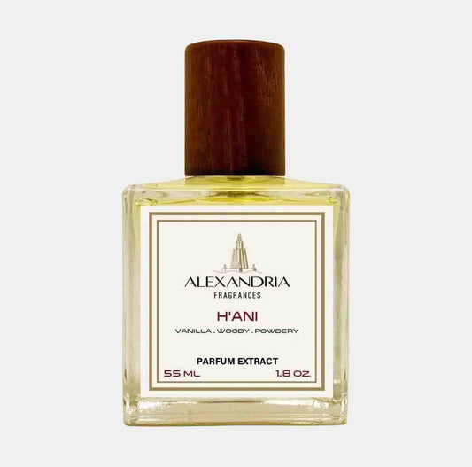 A clear glass bottle of Alexandria Fragrances H'Ani sample, featuring a wooden cap. The label highlights its notes of vanilla, wood, and powder, with a capacity of 55 mL (1.8 oz) parfum extract.