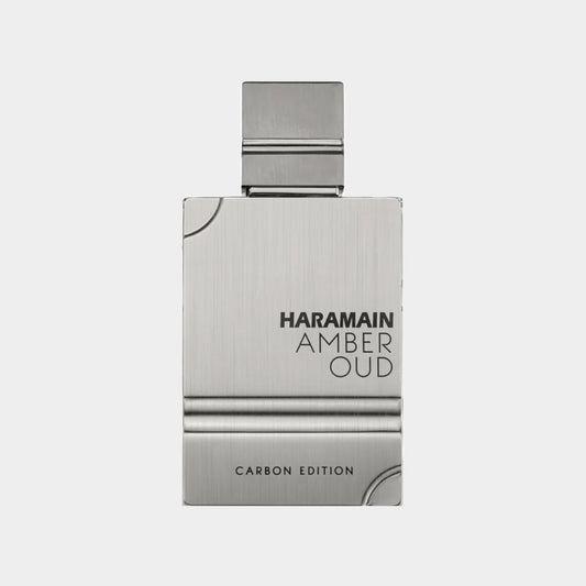 Al Haramain Amber Oud Carbon Edition Cologne Sample features a sleek, metallic bottle with a minimalist design. The label prominently displays the brand name and product title, highlighting its luxurious appeal.