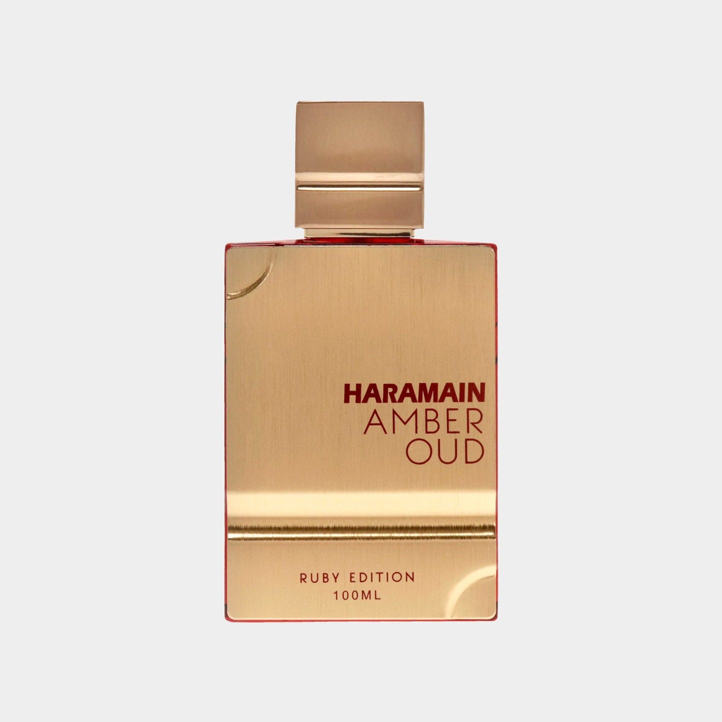 A luxurious gold and red bottle of Al Haramain Amber Oud Ruby Edition perfume, featuring a sleek design and labeled as 100ml. The elegant packaging reflects a premium fragrance experience.