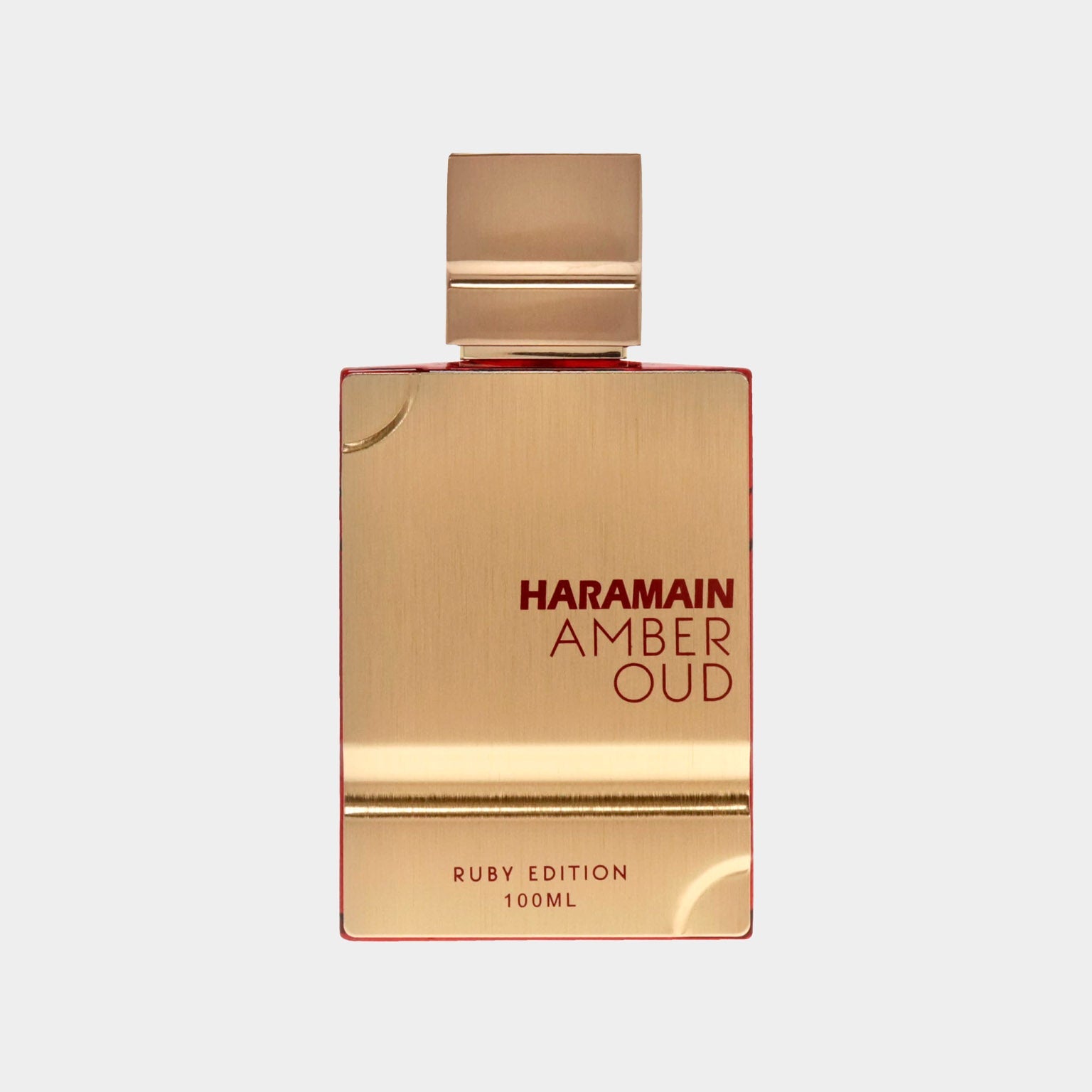A luxurious gold and red bottle of Al Haramain Amber Oud Ruby Edition perfume, featuring a sleek design and labeled as 100ml. The elegant packaging reflects a premium fragrance experience.
