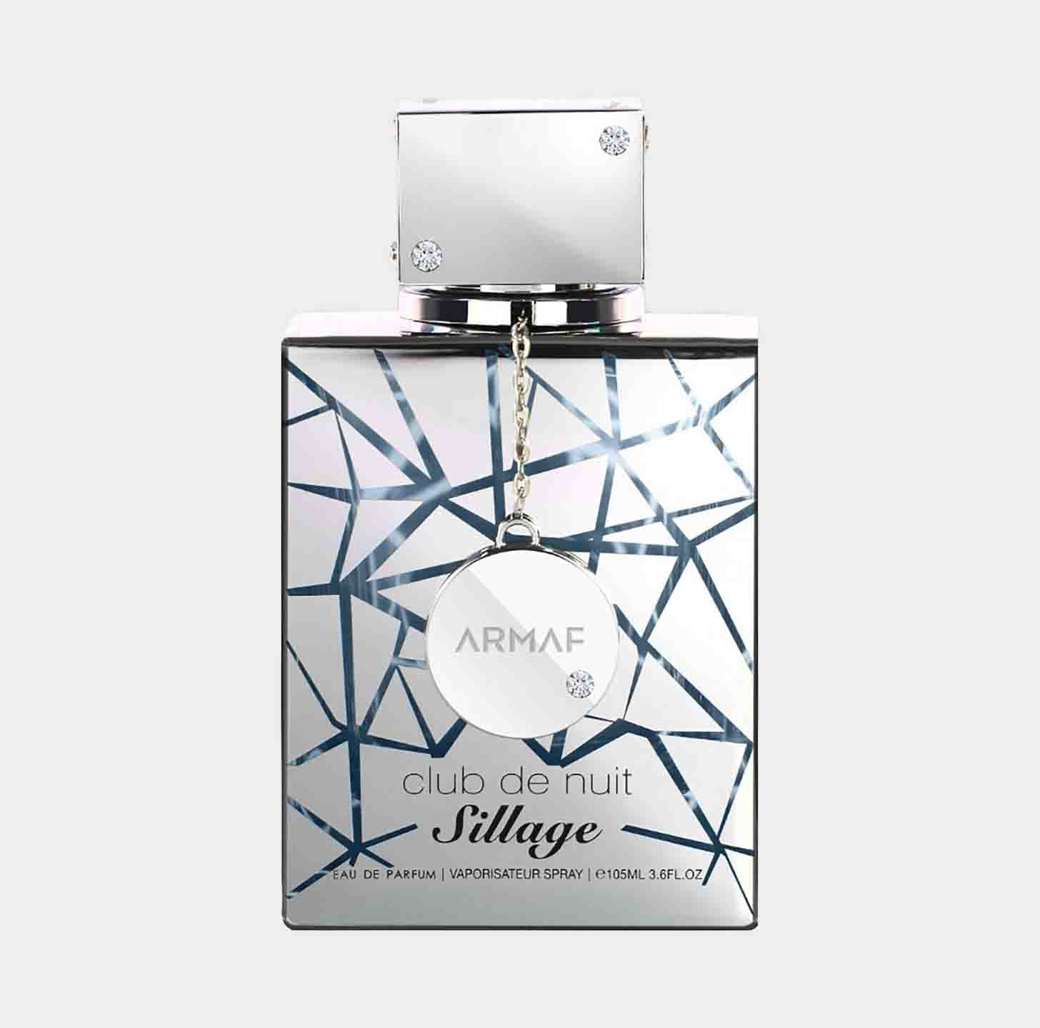 A sleek, geometric bottle of Armaf Club de Nuit Sillage Sample, featuring a shimmering design and a prominent silver cap. The bottle is labeled with the brand name and fragrance details.