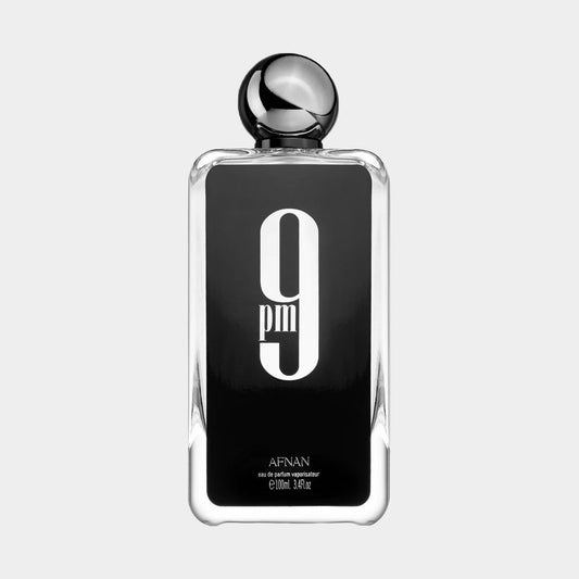 Afnan Perfumes 9PM full bottle features a sleek, modern design with a black label and bold white lettering, showcasing its 100ml eau de parfum. The bottle is topped with a distinctive black cap for a contemporary look.