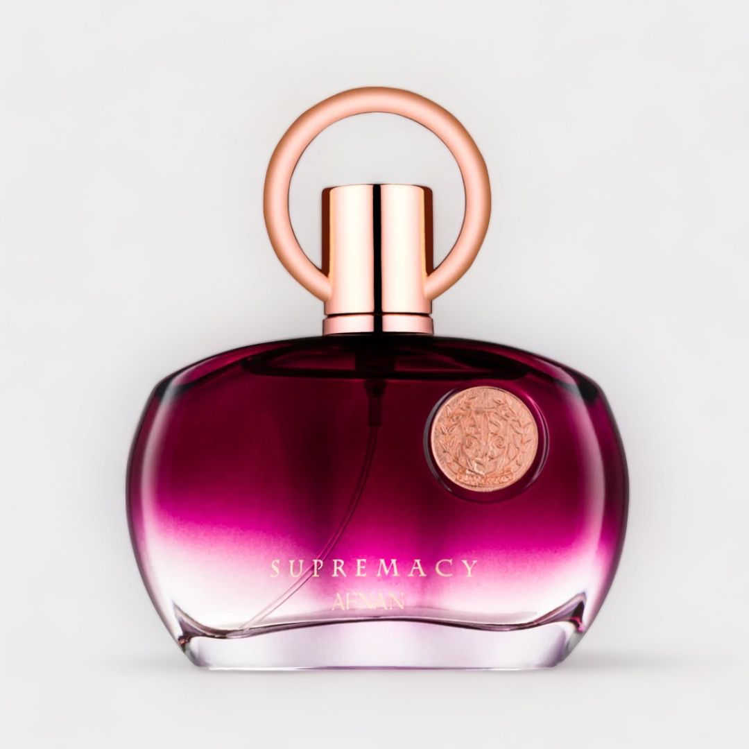 Afnan Perfumes Supremacy Pour Femme Purple Sample features a stylish ombre bottle in shades of purple, accented by a unique circular cap and a decorative emblem. This elegant fragrance is designed for a sophisticated feminine scent experience.