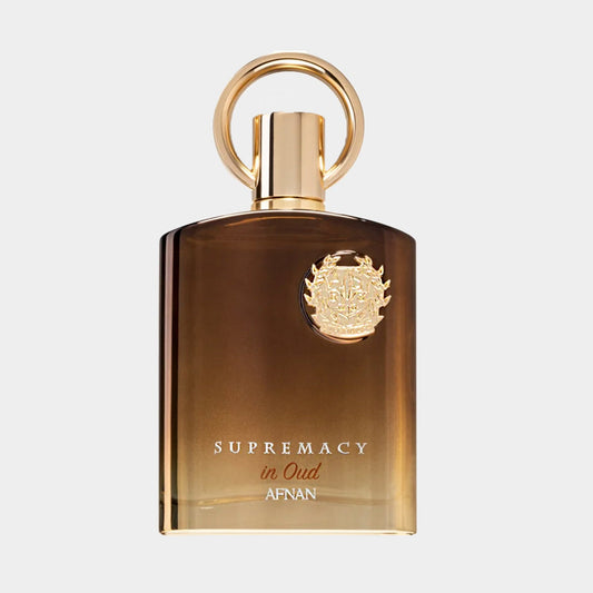 Afnan Perfumes Supremacy in Oud Sample features an elegant brown glass bottle with a gold emblem and a round cap, showcasing its luxurious fragrance inspired by oud. The design reflects sophistication and richness, perfect for perfume enthusiasts.