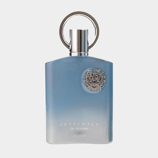 Afnan Perfumes Supremacy in Heaven sample, featuring a sleek blue ombre bottle with a circular silver cap and an embossed logo on the front. The elegant design showcases the fragrance's fresh and uplifting essence.