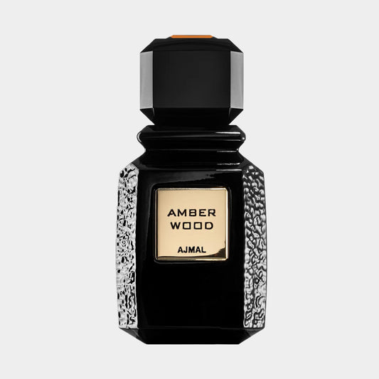 Ajmal Amber Wood Sample is a sleek, black bottle with a textured silver base and a gold label featuring the name. The design exudes elegance, capturing the essence of the fragrance inside.
