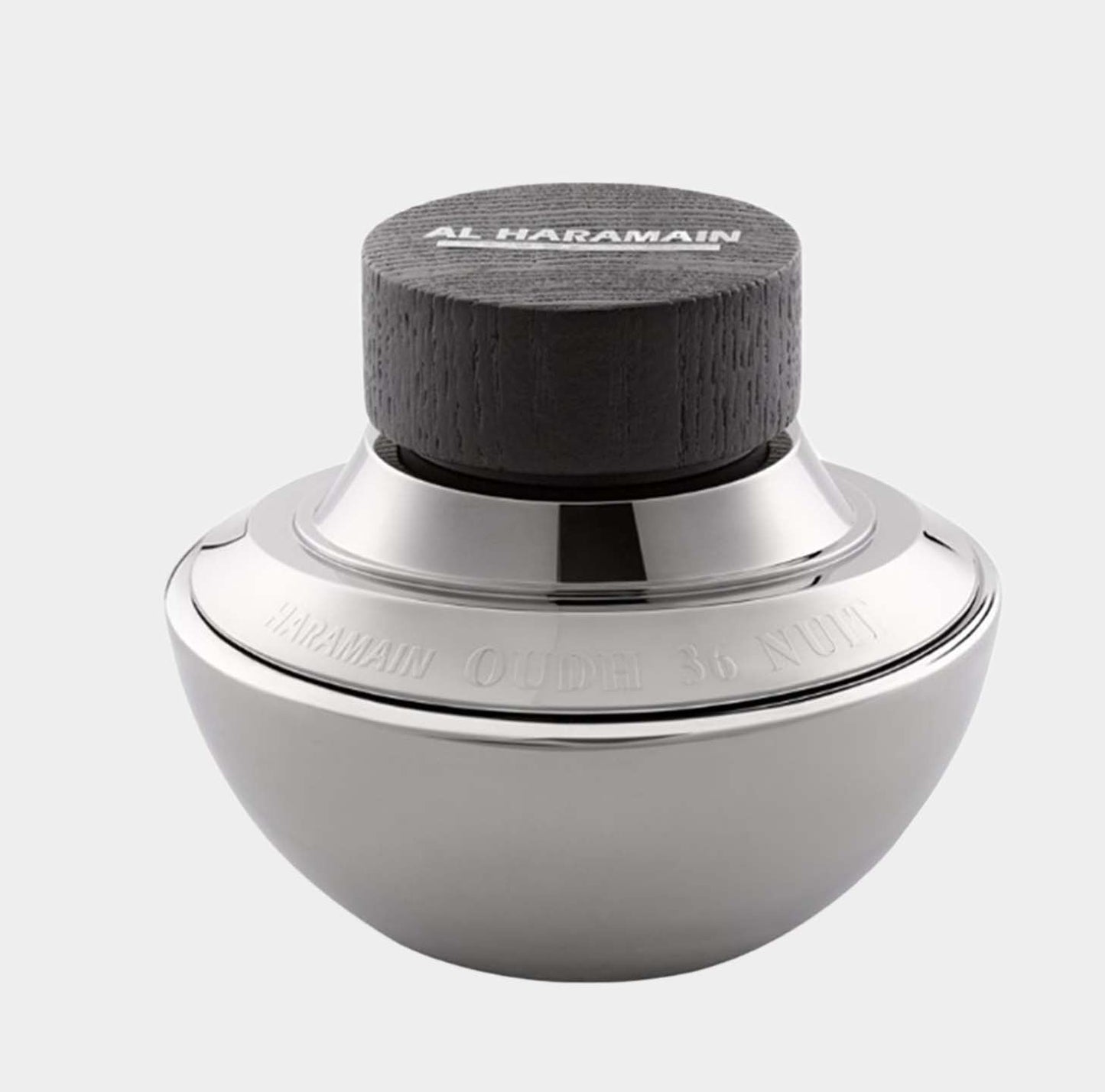 A sleek, metallic fragrance bottle of Al Haramain Oudh 36 Nuit Sample, featuring a dark wooden cap and an elegant round design.