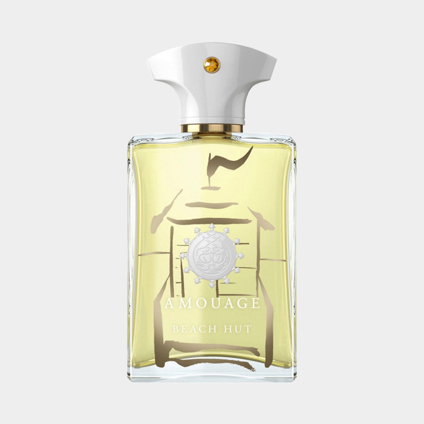 A clear glass bottle of Amouage Beach Hut Man Made in Oman, featuring a white cap and a minimalist design with a light yellow fragrance inside. The bottle showcases the brand's emblem prominently on the front.