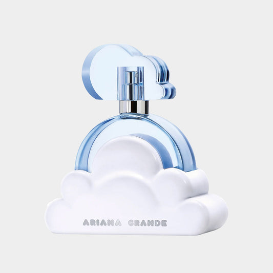 A close-up of the Ariana Grande Cloud Sample perfume bottle, featuring a whimsical design with a blue cloud and rainbow motif atop a fluffy white base.
