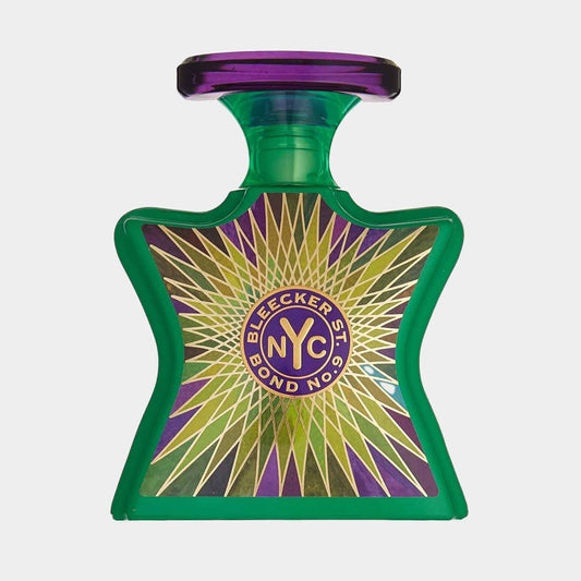 A full bottle of Bond No.9 Bleecker Street fragrance, featuring a striking green bottle with a purple cap and a sunburst design on the label.