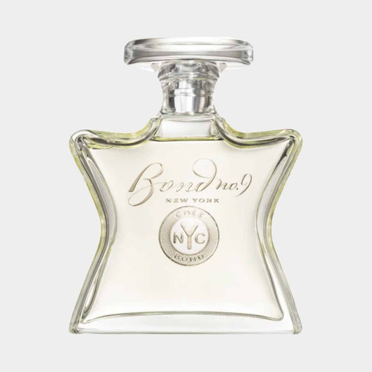 A full bottle of Bond No. 9 Chez Bond, featuring a distinctive star-shaped glass design with a silver medallion and elegant label. The fragrance is presented in a clear, light yellow liquid.