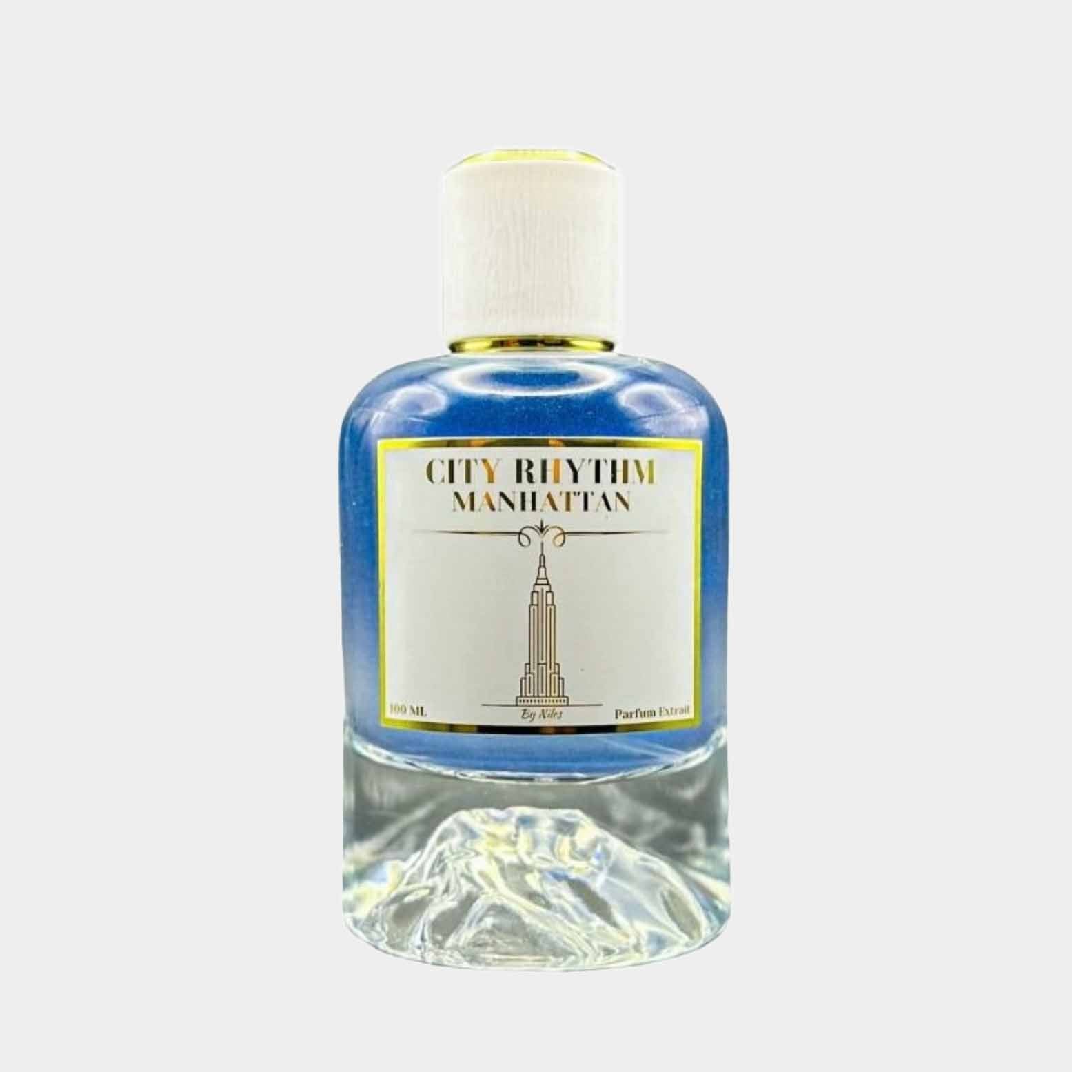 A bottle of 'City Rhythm Manhattan Sample' perfume, featuring a sleek design with a blue liquid, topped with a white cap and adorned with a gold label displaying the iconic skyline motif.