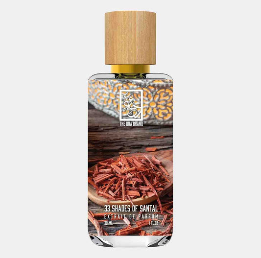 Dua 33 Shades of Santal Sample, a 30ml bottle of extrait de parfum featuring a sleek design with a wooden cap, showcasing aromatic sandalwood shavings in the foreground.