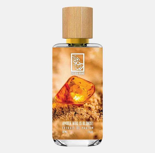 A bottle of Dua Amber Who is Blonde, featuring a wooden cap and an amber-colored gemstone on the label, showcasing its luxurious fragrance in a 30 ml size.