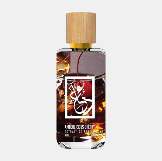 Dua Amberlicious Cherry Sample, featuring a sleek bottle with a wooden cap, containing amber-colored perfume. The label showcases the fragrance name in elegant typography.