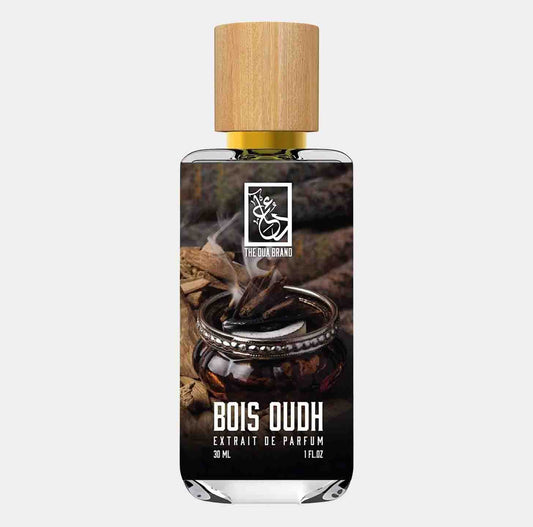 A 30 ml bottle of Dua Bois Oud Sample, featuring a wooden cap and a stylish design that showcases the scent's luxurious essence, surrounded by elements of nature.
