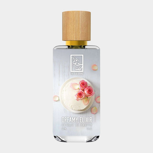 A stylish sample bottle of Dua Dreamy Elixir, featuring a bamboo cap and elegant packaging adorned with roses and a creamy dessert, showcasing its luxurious fragrance.