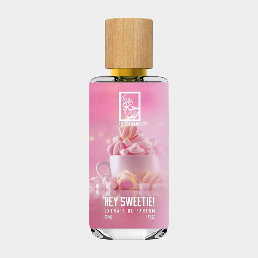 A elegant bottle of Dua Hey Sweetie Sample, featuring a delicate design with a wooden cap and a pink label. The bottle contains 30 mL of Extrait de Parfum, exuding a sweet and inviting aesthetic.