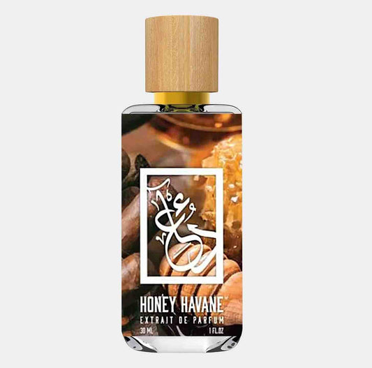 A bottle of Dua Honey Havane Sample, featuring a sleek design with a wooden cap and an elegant label that showcases its name and scent details. The fragrance is inspired by rich notes of honey and tobacco.