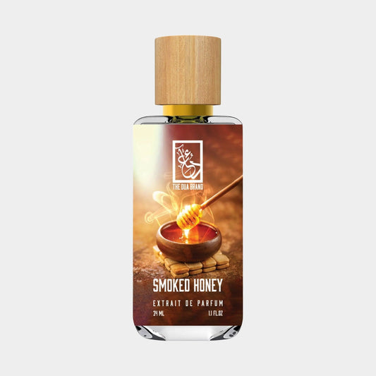 A bottle of Dua Smoked Honey Sample, featuring a wooden cap and an image of honey being drizzled into a bowl, with branding prominently displayed on the front.