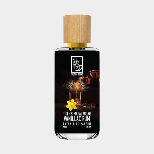 A bottle of Dua Tiger's Madagascar Vanillac Rum Sample, featuring a wooden cap and an elegant label with a floral design. The 30ml bottle showcases a dark background with hints of rum and tropical elements.