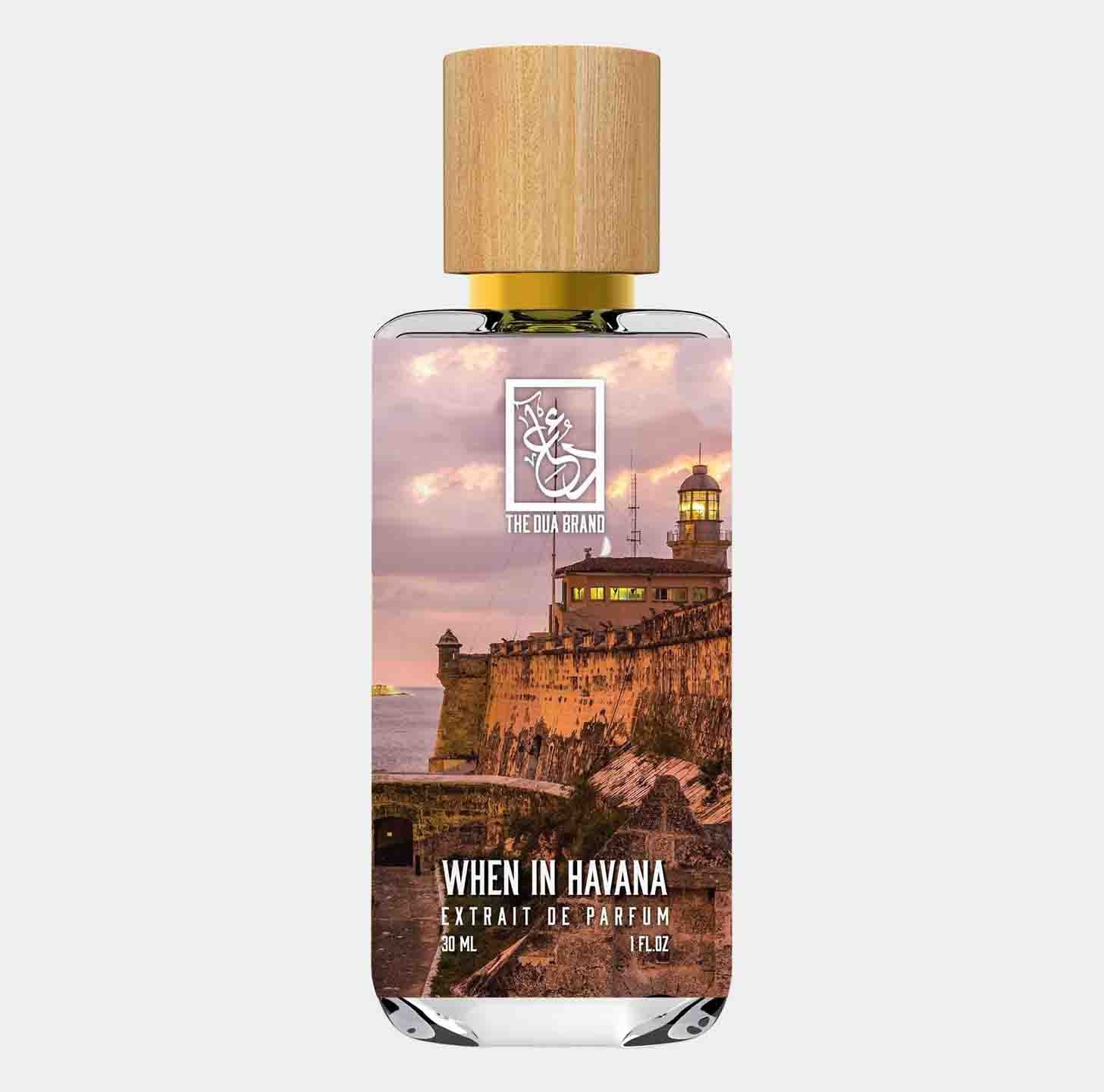 A bottle of 'Dua When in Havana' perfume, featuring a scenic label with a sunset view of a lighthouse by the waterfront. The elegant design includes a wooden cap and claims a volume of 30 mL.