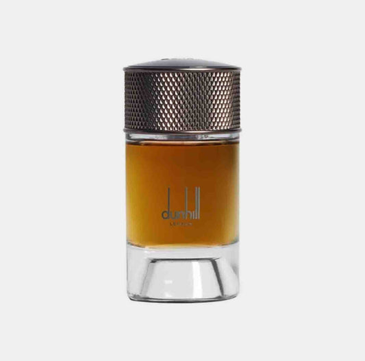 A small glass sample bottle of Dunhill Signature Egyptian Smoke, featuring a metallic top and a rich amber liquid inside. The bottle is elegantly designed, showcasing the fragrance's sophistication.
