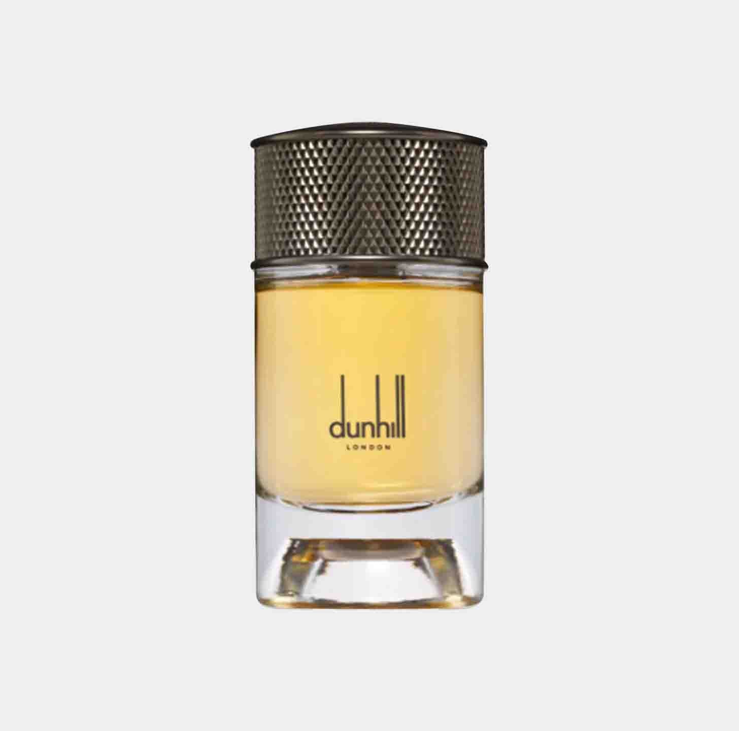 A small glass bottle of Dunhill Signature Indian Sandalwood Sample, featuring a textured silver cap and a clear liquid inside. The elegant design highlights the brand name Dunhill London on the front.