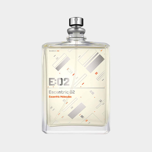 A clear rectangular bottle of Escentric Molecules 02 EDT Sample, featuring a minimalist design with geometric patterns and a silver spray nozzle. The label displays E:02 and Escentric 02 in modern typography.