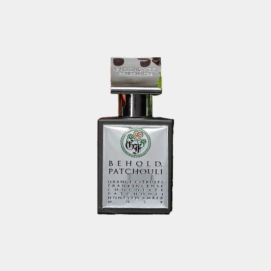 Gallagher Fragrances Behold, Patchouli Sample is a small, elegant fragrance bottle featuring a stylish design. The label highlights its key notes of orange, citrus, and patchouli.