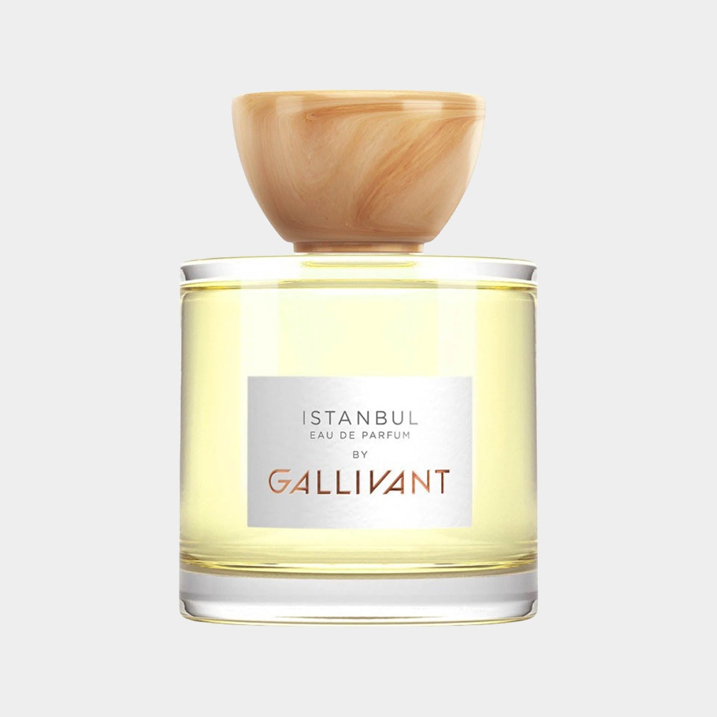 Gallivant Istanbul Sample is a clear glass parfum bottle with a wooden cap, showcasing a light yellow fragrance inside, elegantly labeled with the brand name.