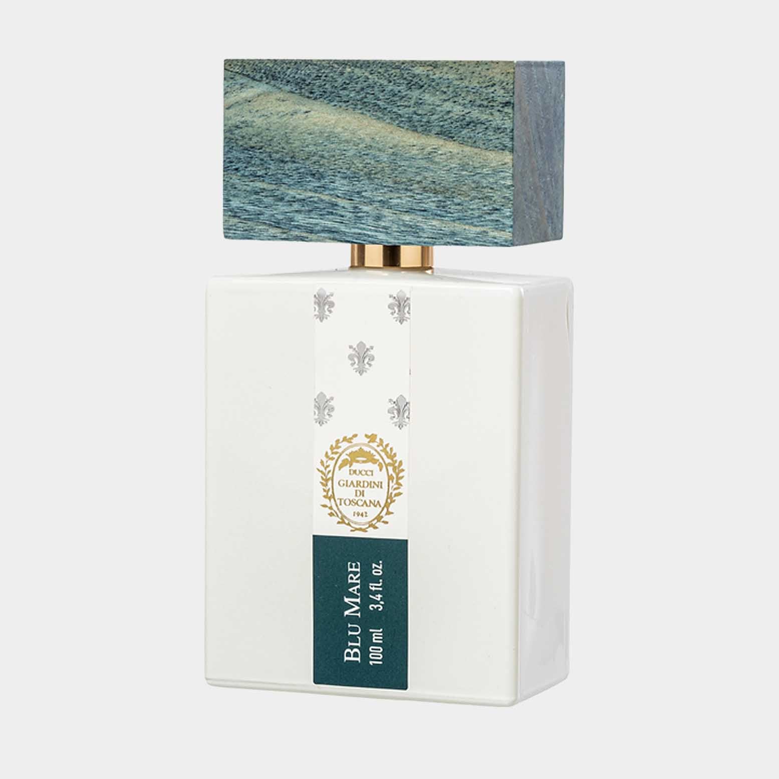 A white rectangular perfume bottle labeled Giardini di Toscana Blu Mare Sample with a textured blue cap resembling ocean waves, featuring a gold accent and floral emblem.