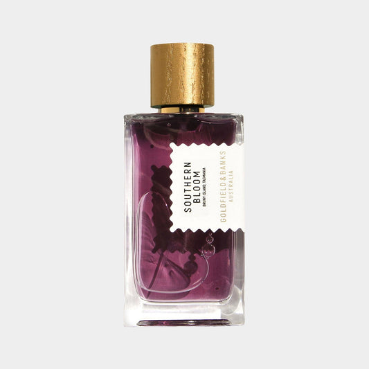 A glass perfume bottle of Goldfield & Banks Australia Southern Bloom Sample, featuring a purple floral liquid and a gold cap, elegantly labeled to showcase the brand and fragrance name.