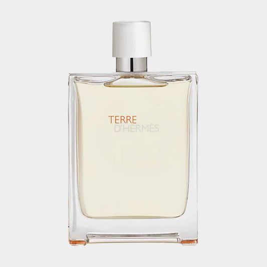 A sample bottle of Hermès Terre d'Hermes Eau Très Fraîche, featuring a sleek, transparent design with a minimalist label showcasing the name TERRE in orange.