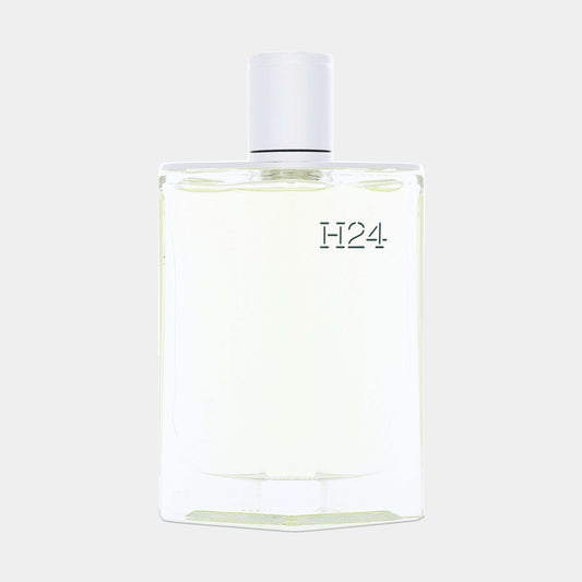 A clear glass sample bottle of Hermès H24 Eau de Toilette, featuring a minimalist design with a white cap and the brand name etched on the front.