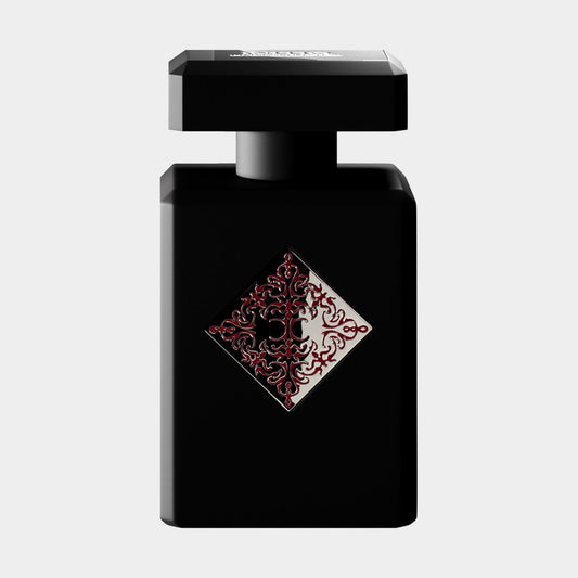 A sleek black perfume bottle for Initio Addictive Vibration Sample, featuring an ornate red decorative design on the front. The bottle's modern shape adds elegance to the luxurious fragrance inside.