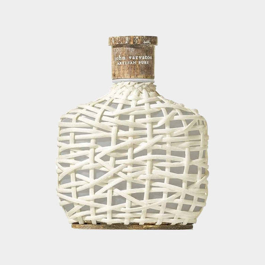 A sample bottle of John Varvatos Artisan Pure, featuring a unique woven white design and a natural cork top. The artisanal look reflects a blend of sophistication and creativity.
