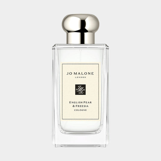 A clear glass bottle of Jo Malone London English Pear & Freesia sample cologne, featuring a sleek design and a silver cap, elegantly labeled to highlight its floral and fruity scent.