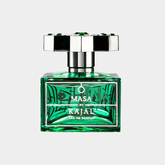 A full bottle of Kajal Masa perfume, featuring a striking emerald green glass design with an elegant stopper. The label reads Masa by Kajal and Eau de Parfum.